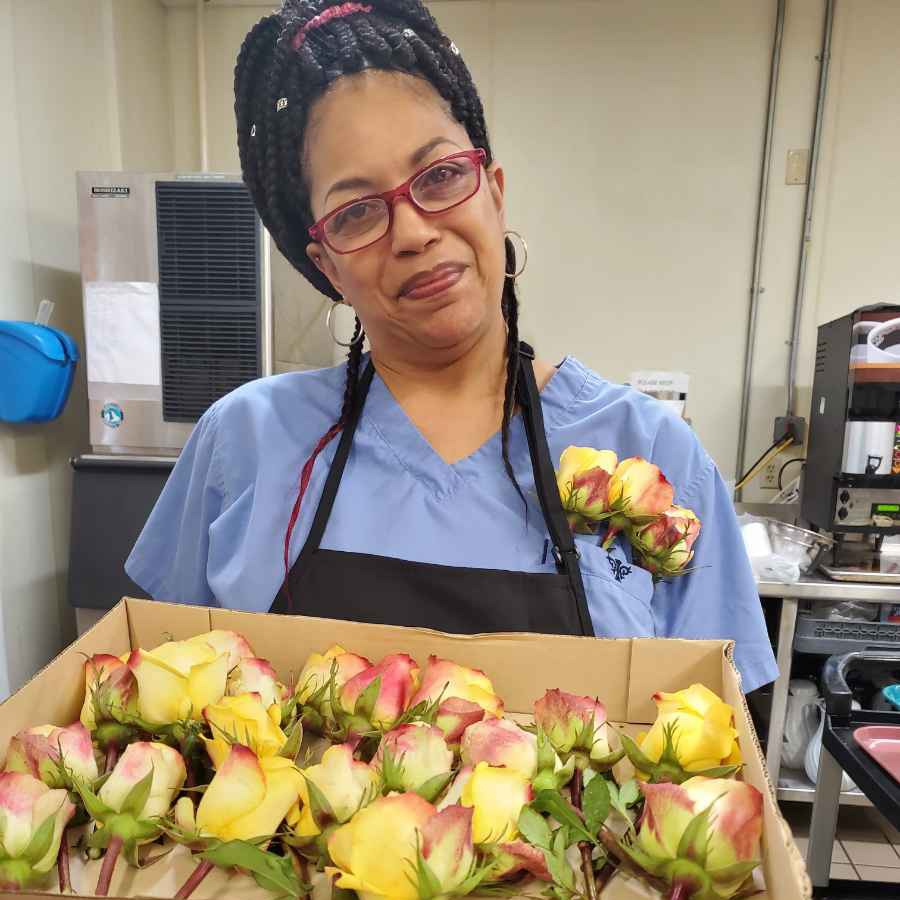 food service staff holding flowers